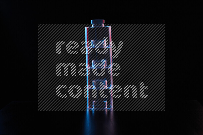 Glassware with rim light in red and blue against black background