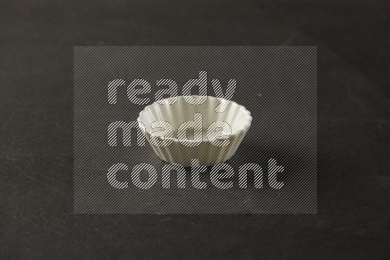 white ceramic round sauce bowl on grey textured countertop