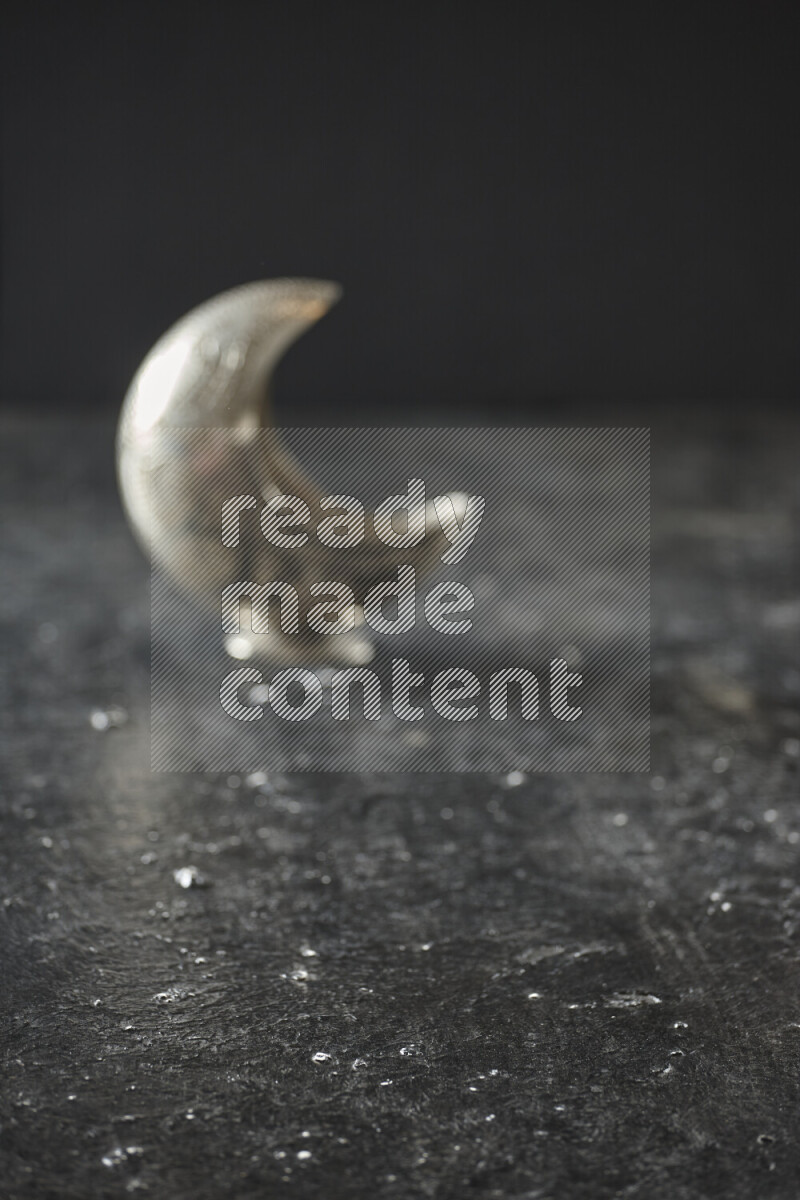 A lantern placed on a textured black background