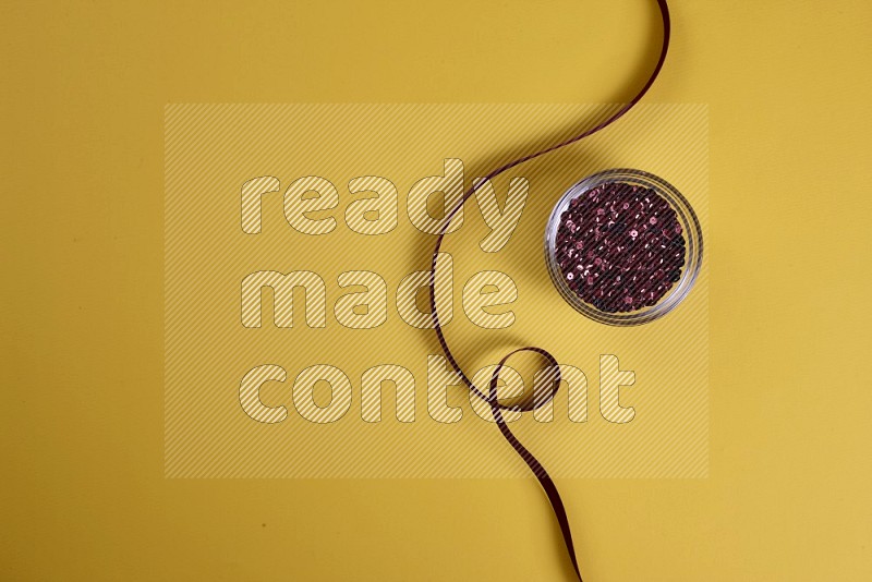 Red sewing supplies on yellow background