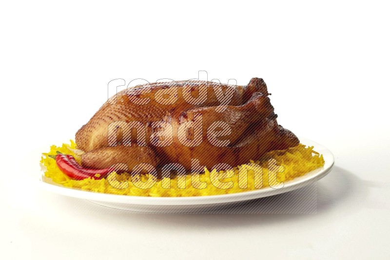 yellow  basmati Rice with  whole roasted chicken on a white rounded plate direct on white background