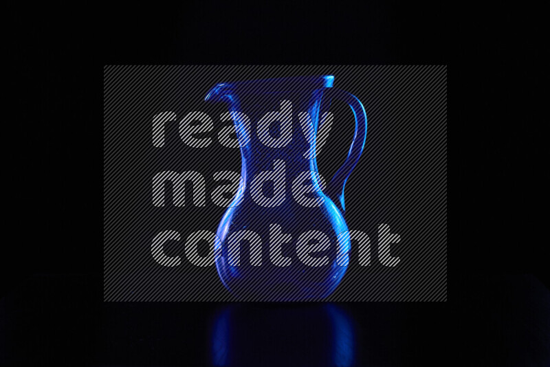 Glassware with rim light in blue against black background