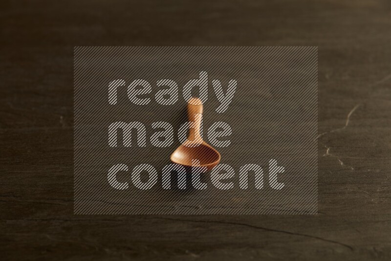 wooden spoon on black slate background