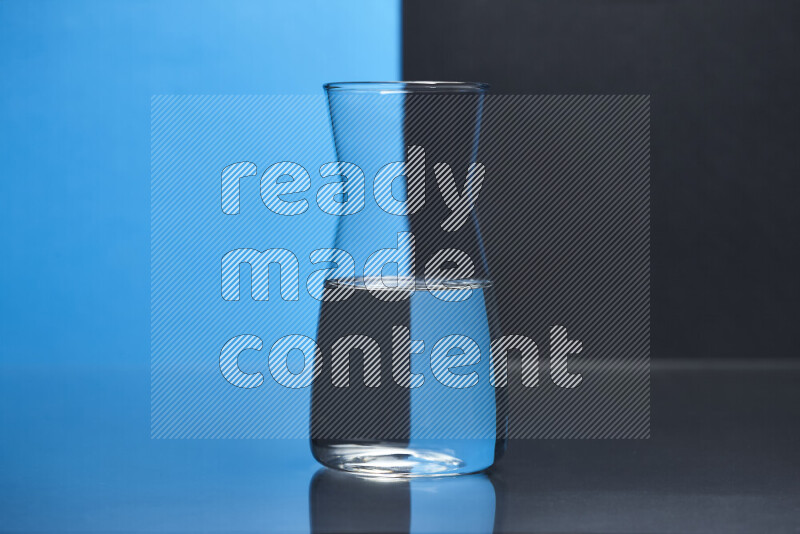 The image features a clear glassware filled with water, set against blue and black background