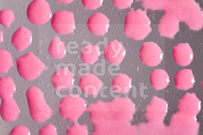 Close-ups of abstract pink paint droplets on the surface