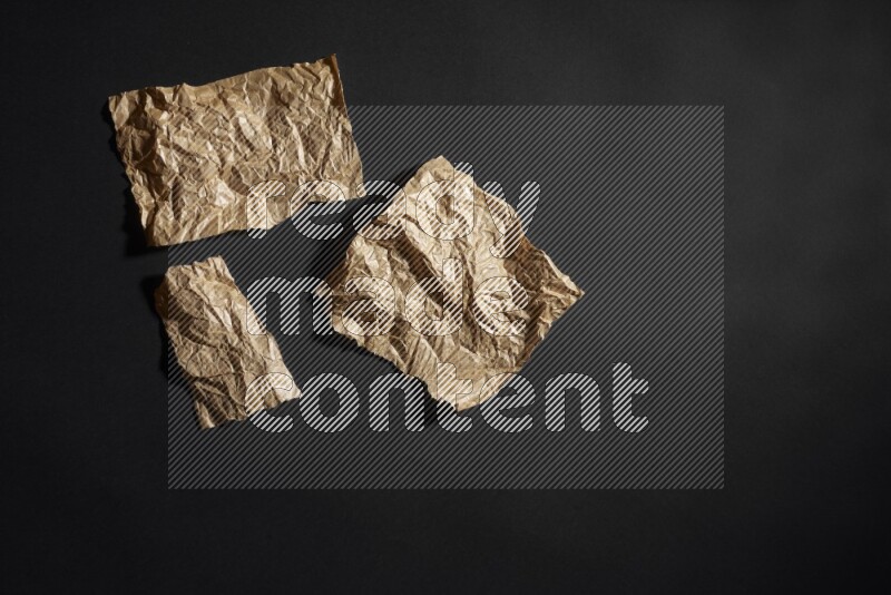 Crumpled craft paper on black background
