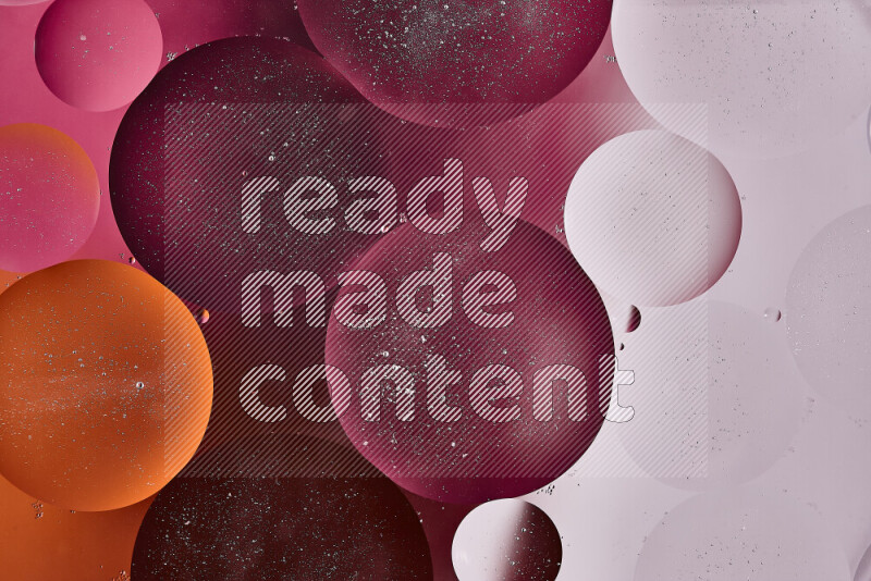 Close-ups of abstract oil bubbles on water surface in shades of white, orange and pink