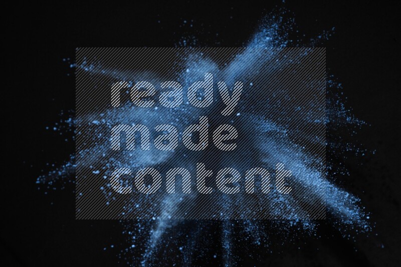 Blue powder explosion on black background