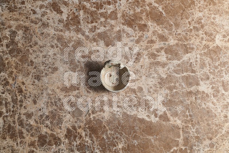 Top View Shot Of A Pottery soap dish On beige Marble Flooring