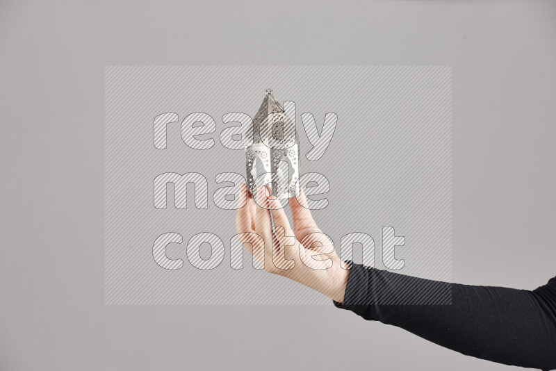 امرأة ترتدي عباءة سوداء تحمل فوانيس رمضانية مختلفة في أوضاع متعددة