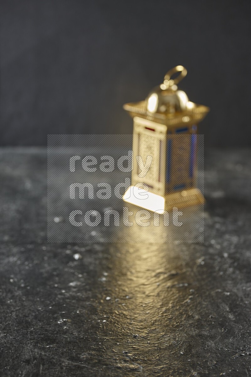 An out of focus lantern on textured black background