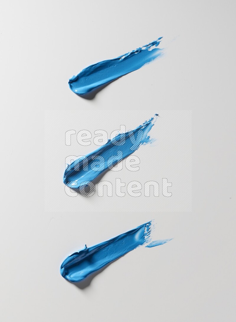 Blue painting knife strokes on white background