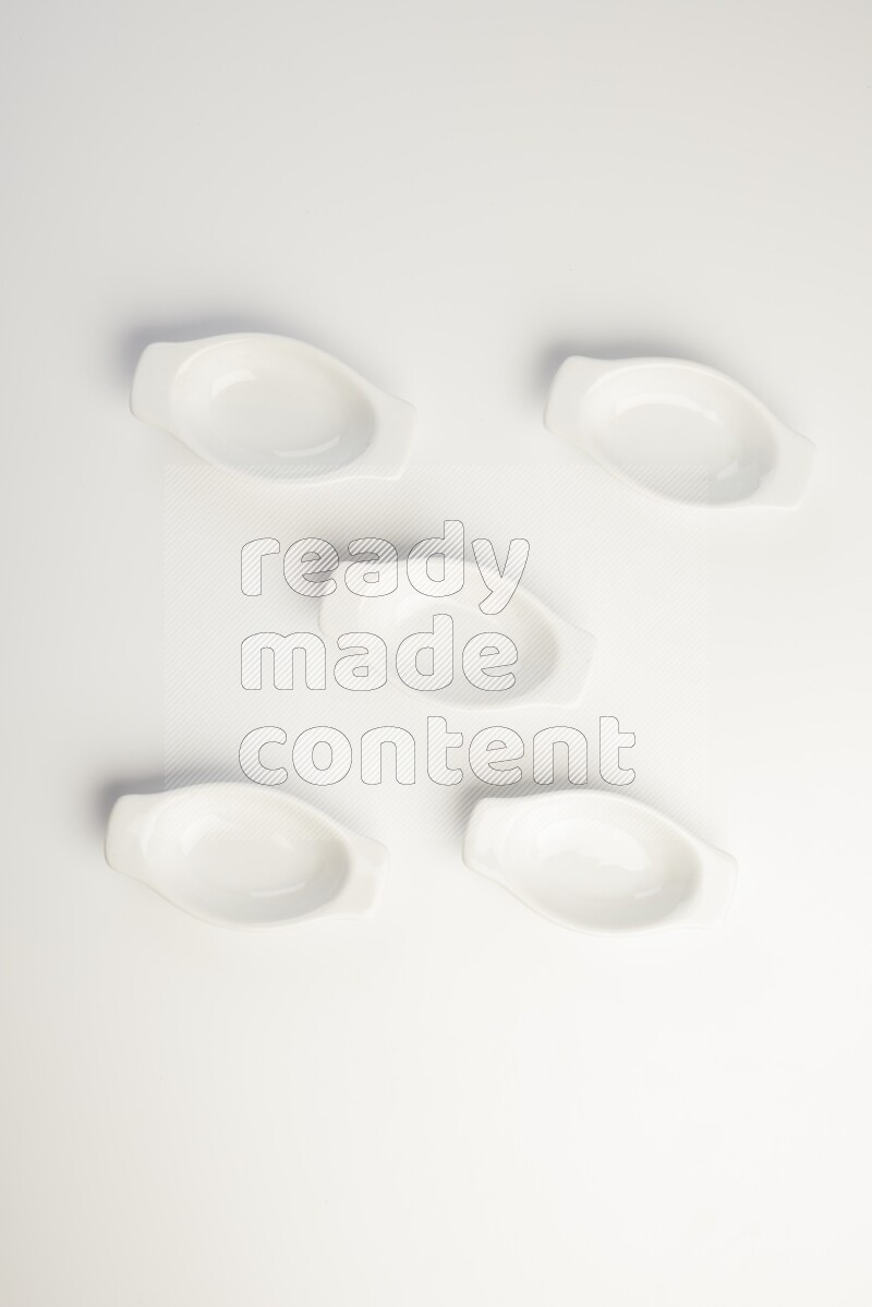white ceramic oval sauce dish on white countertop