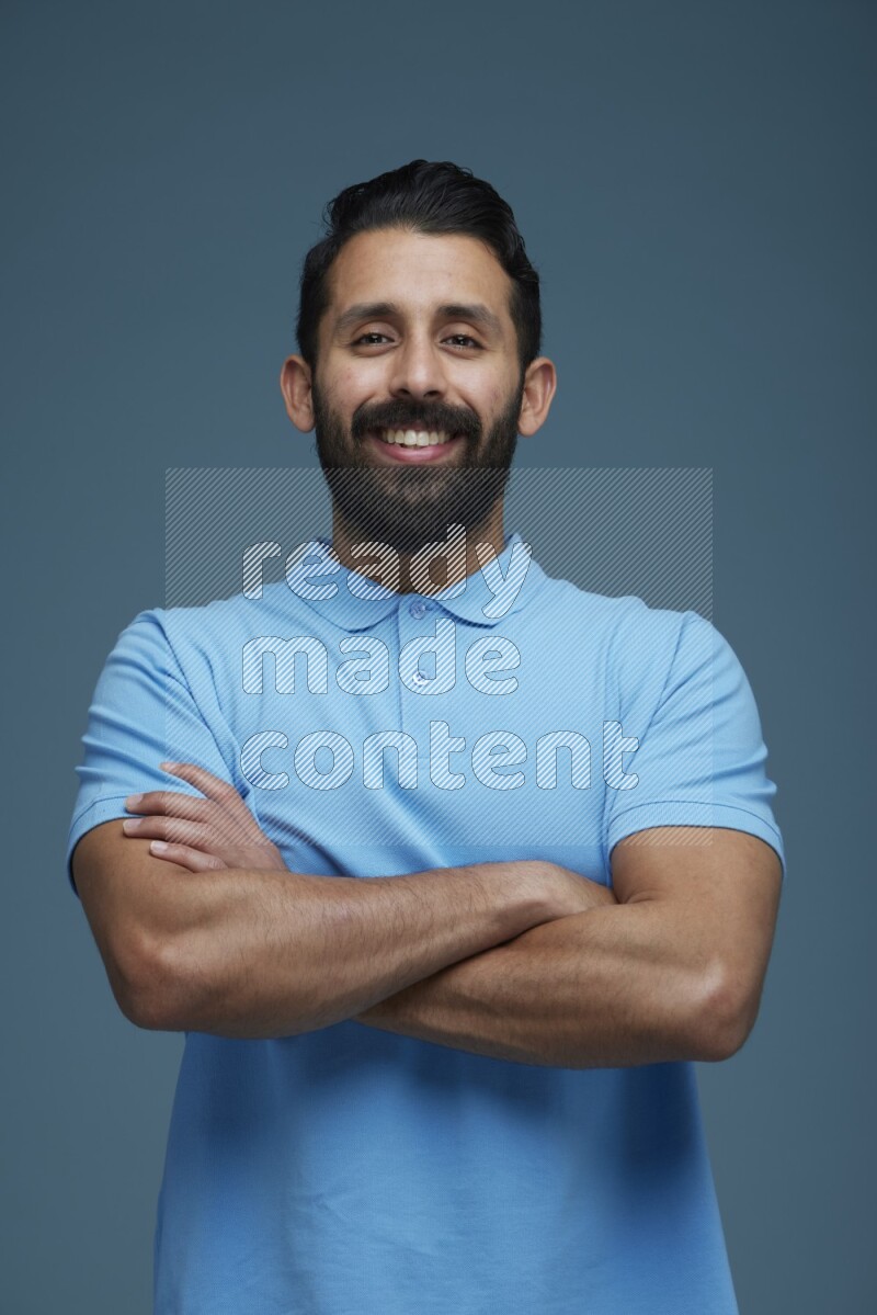 Man posing in a blue background wearing a Blue shirt