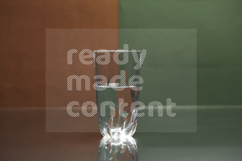 The image features a clear glassware filled with water, set against brown and dark green background