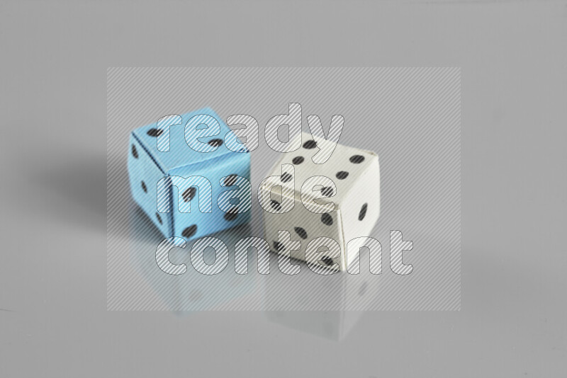Origami dice on grey background