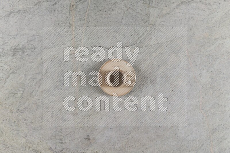 A multicolored pottery Cup on grey marble background