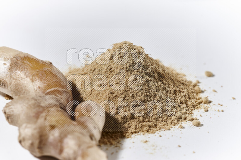 A bunch of ground ginger powder on white background