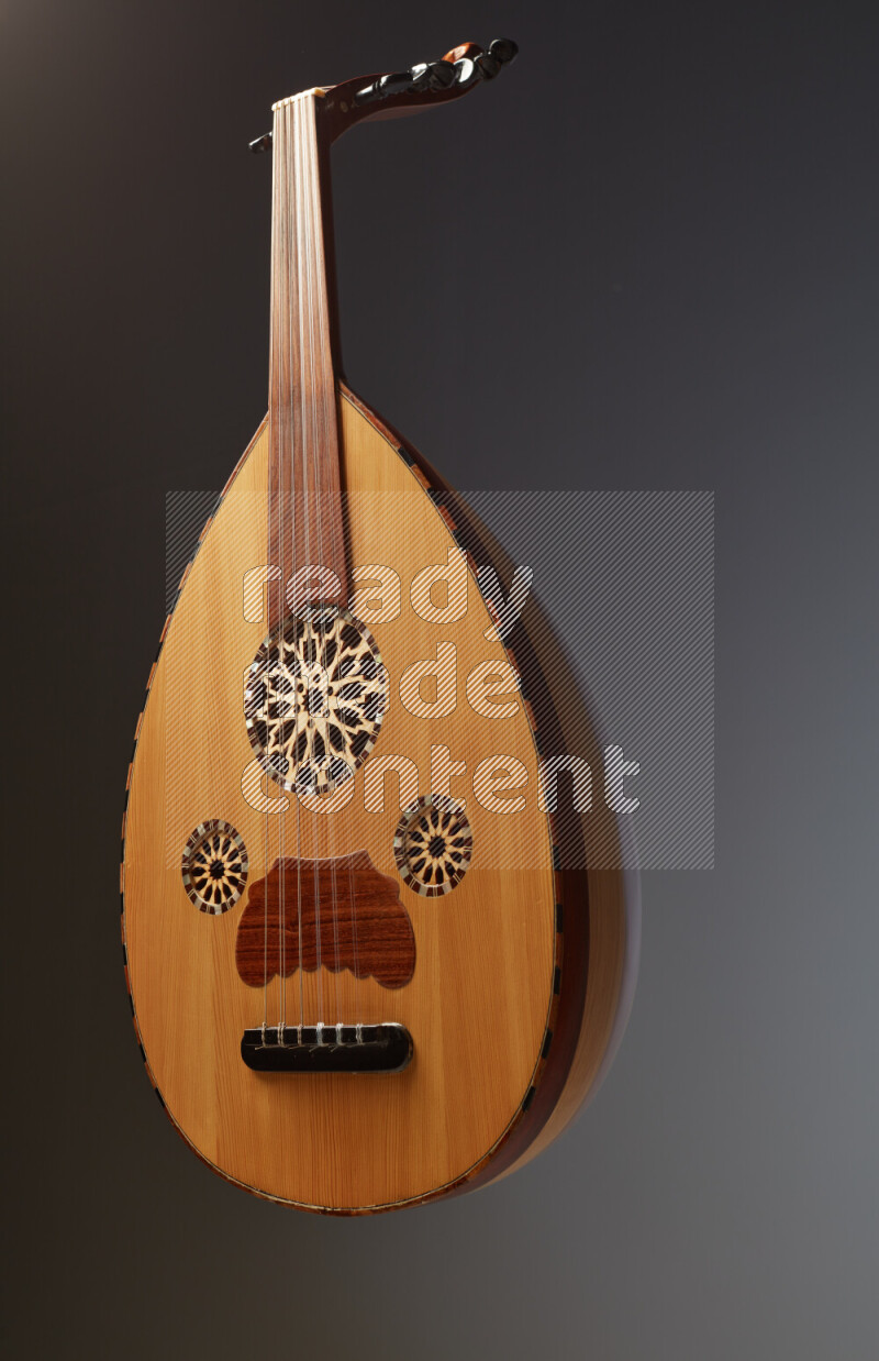 a wooden brown Oud on a gray background