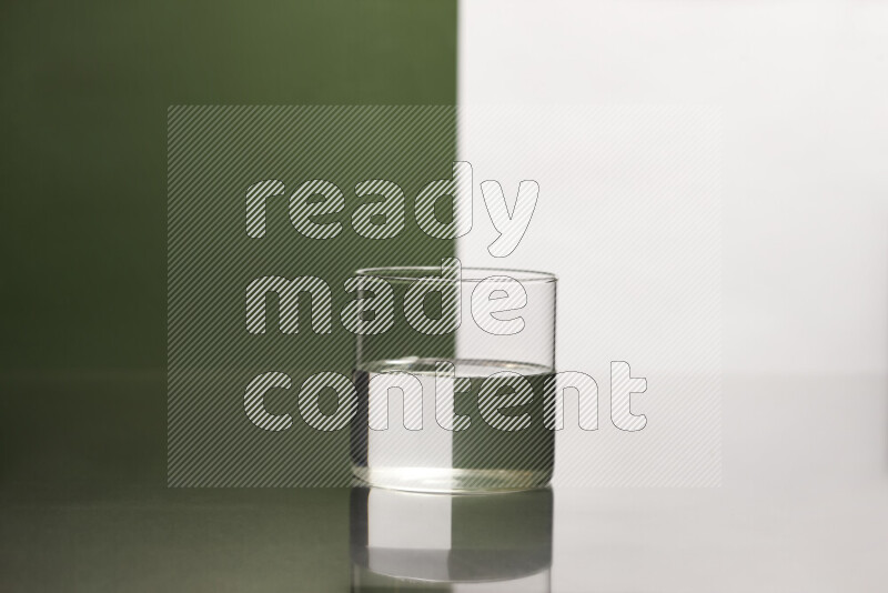 The image features a clear glassware filled with water, set against white and dark green background