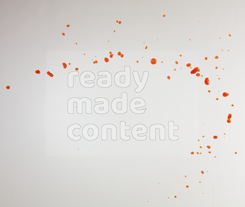 Orange liquid splash and drops on white background