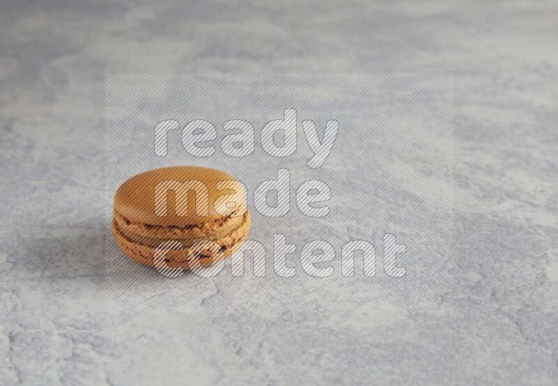 45º Shot of Brown Maple Taffy macaron on white  marble background