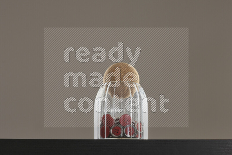 Buttons in a glass jar on black background