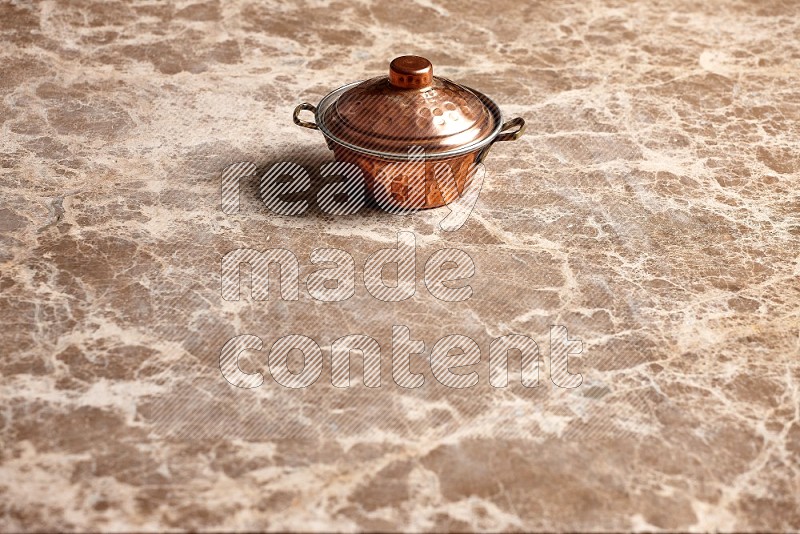 Small Copper Pot on Beige Marble Flooring, 45 degrees
