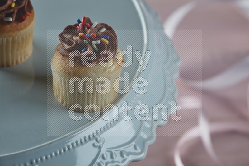 Vanilla mini cupcake topped with chocolate cream
