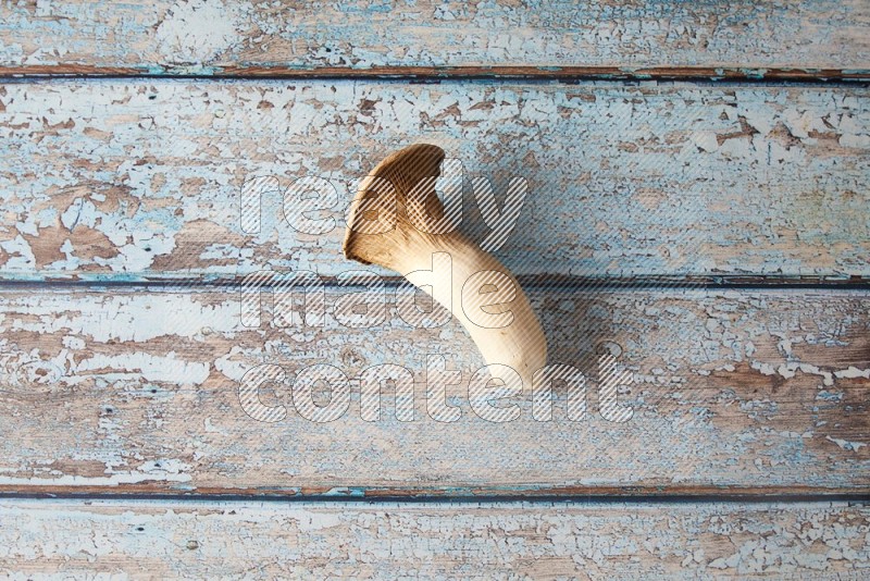Fresh King oysters mushrooms topview on a light blue wooden background