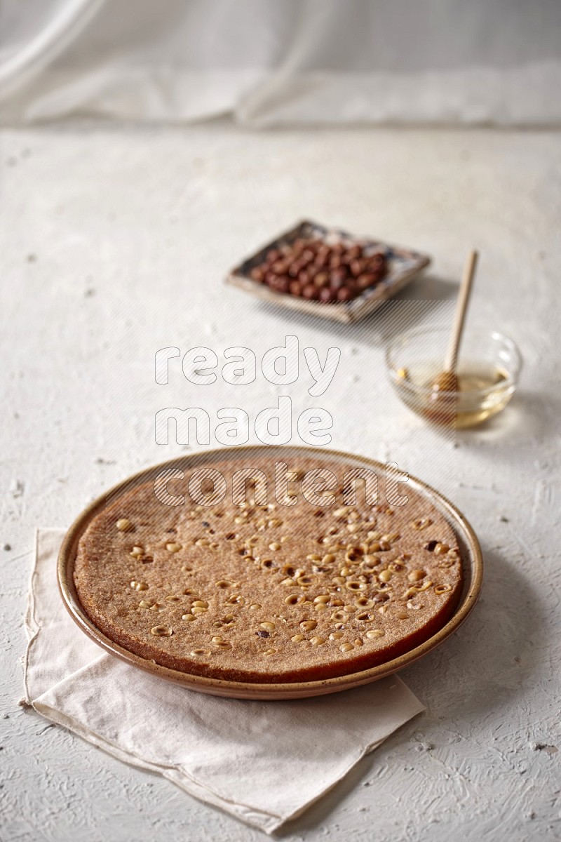 Basbousa with nuts and honey in a light setup