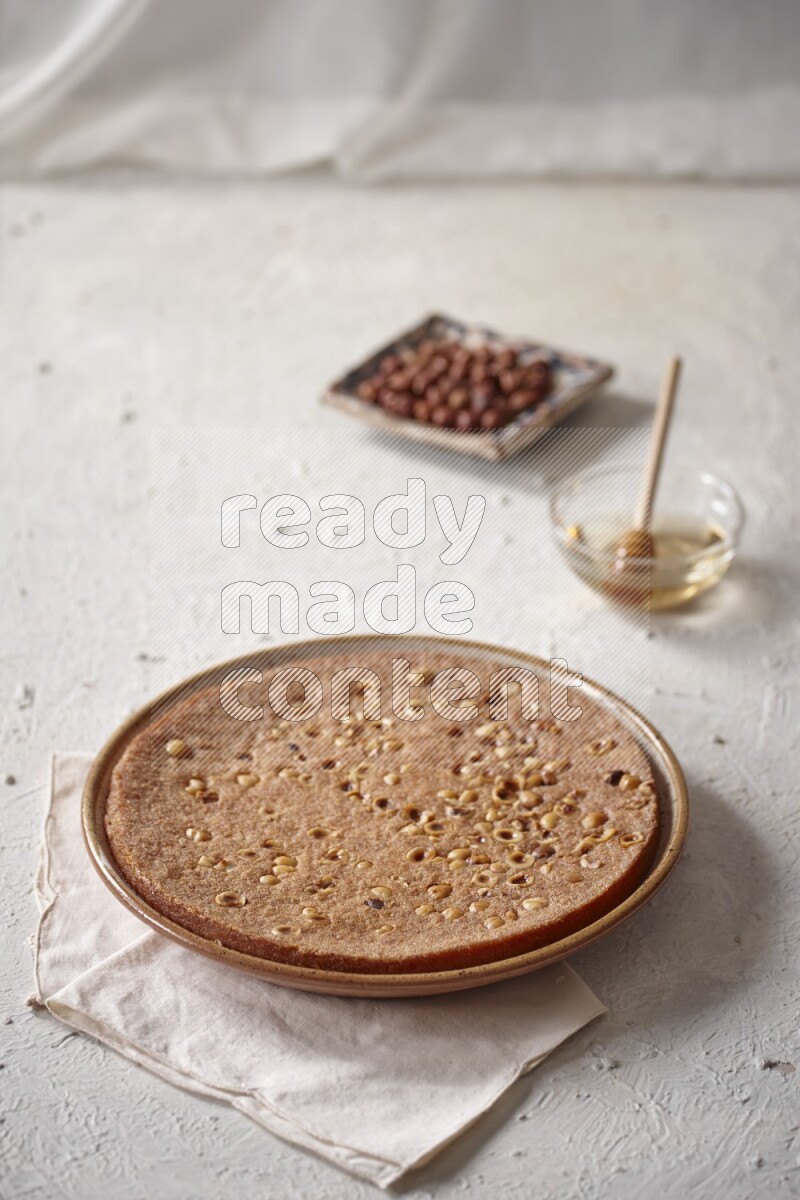 Basbousa with nuts and honey in a light setup