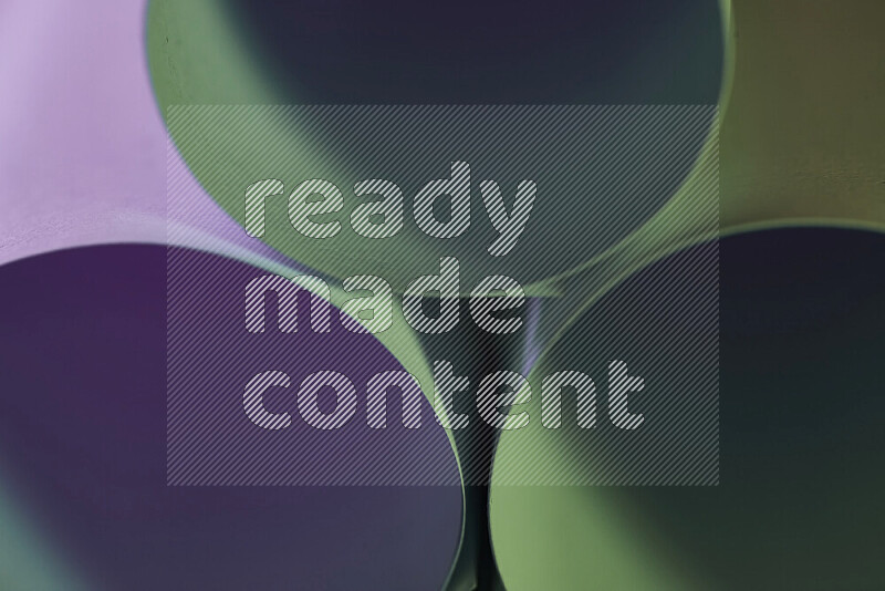 The image shows an abstract paper art with circular shapes in varying shades of green and purple