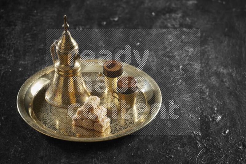 Golash with a drink on a metal tray in a dark setup