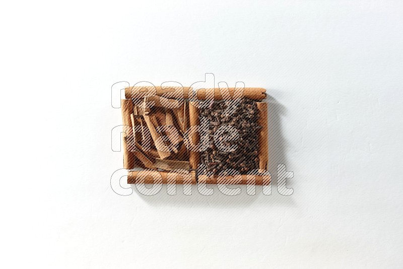 2 squares of cinnamon sticks full of cloves and cinnamon on white flooring