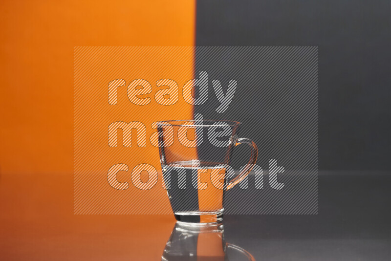 The image features a clear glassware filled with water, set against orange and black background