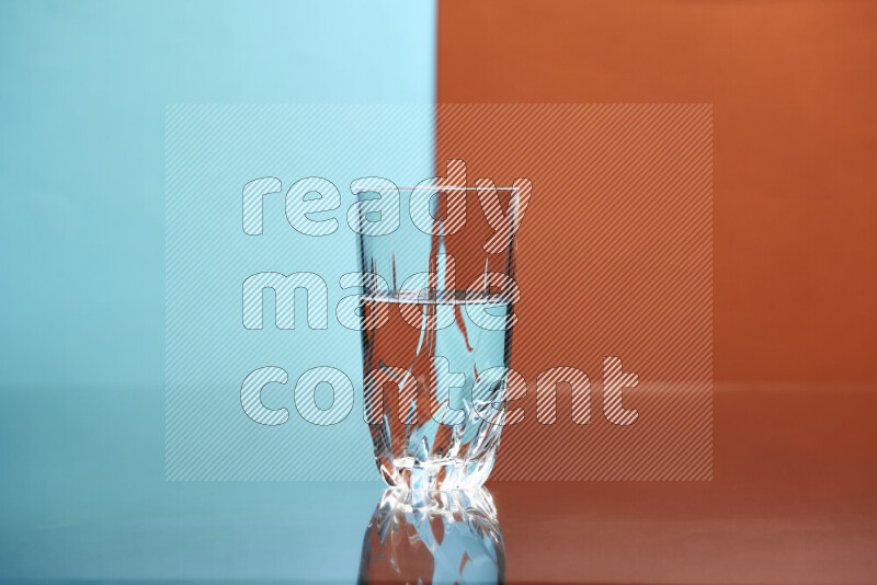 The image features a clear glassware filled with water, set against light blue and dark orange background