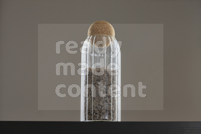 Buttons in a glass jar on black background
