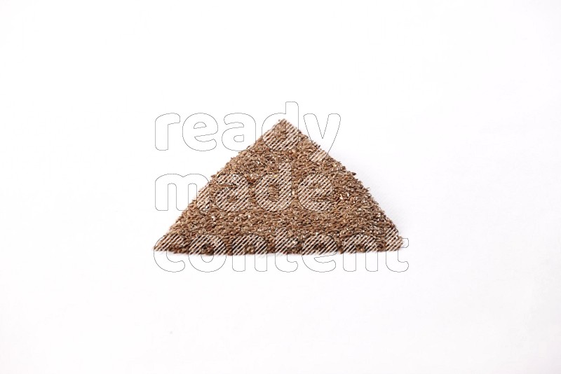 Flax seeds in a triangle shape on a white flooring in different angles