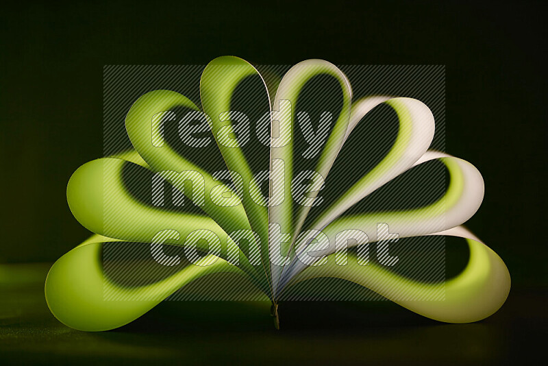 An abstract art piece displaying smooth curves in green gradients created by colored light