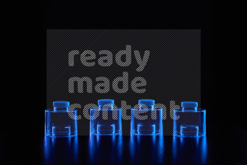 Glassware with rim light in blue against black background