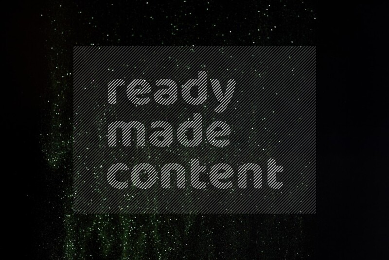 Green glitter powder isolated on black background