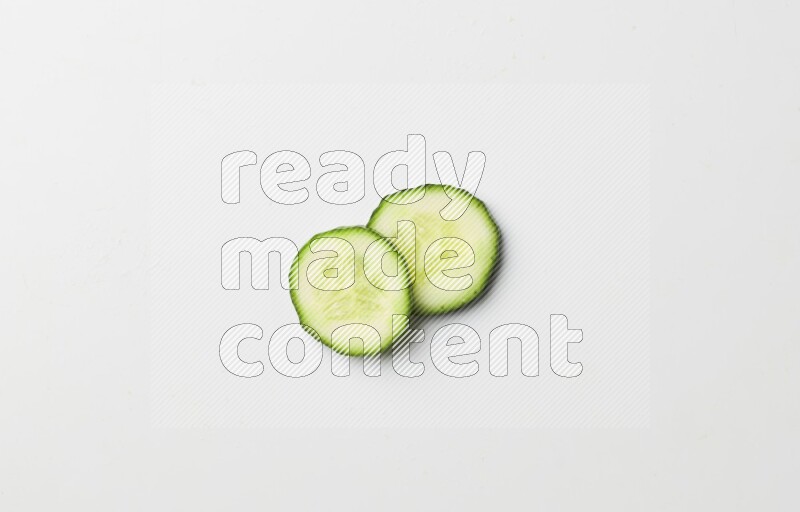 two cucumber slices on white background