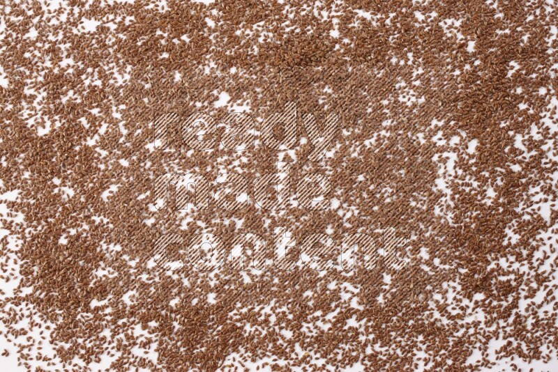 Flax seeds spread on a white flooring