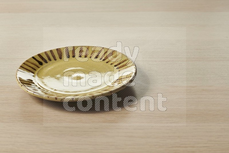 Multicolored Pottery Plate on Oak Wooden Flooring, 15 degrees
