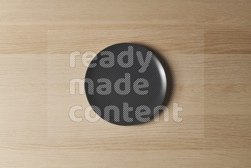 Top View Shot Of A Black Ceramic Circular Plate on Oak Wooden Flooring