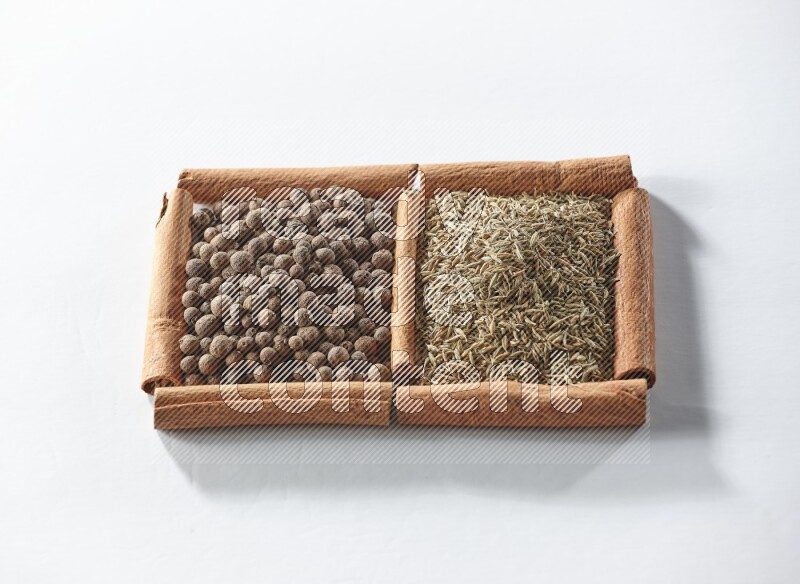 2 squares of cinnamon sticks full of allspice and cumin on white flooring