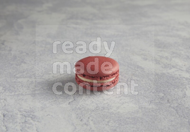 45º Shot of Red Velvet macaron on white  marble background