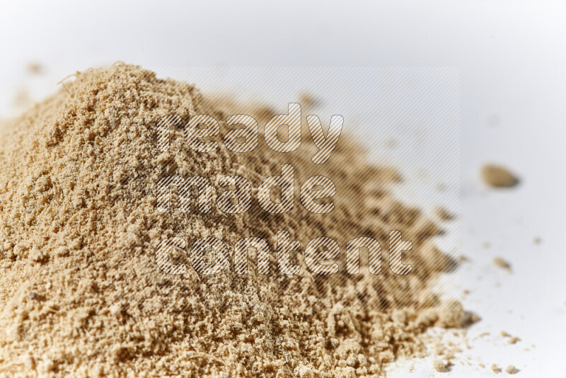 A bunch of ground ginger powder on white background