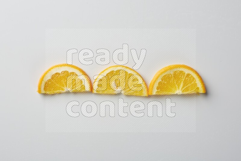 Three halves of an orange slices on white background